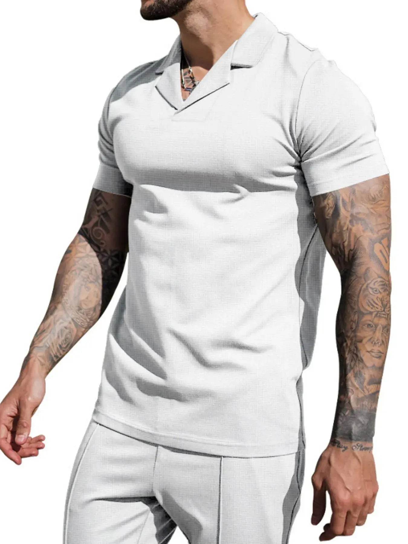 Men's light gray short sleeve top and shorts set with visible arm tattoos.