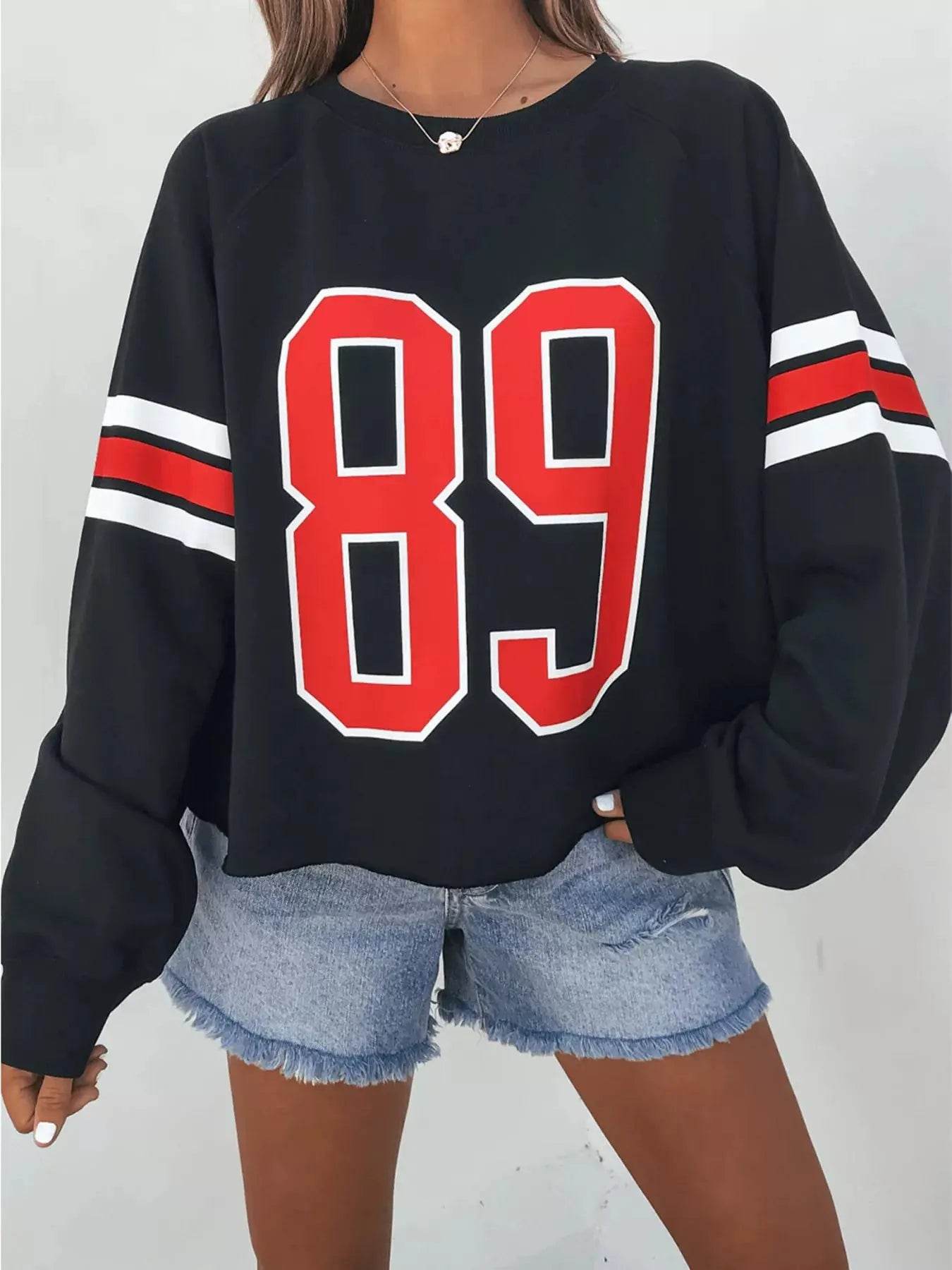 Black long-sleeve sweatshirt with red and white "89" numeric print and striped sleeves.