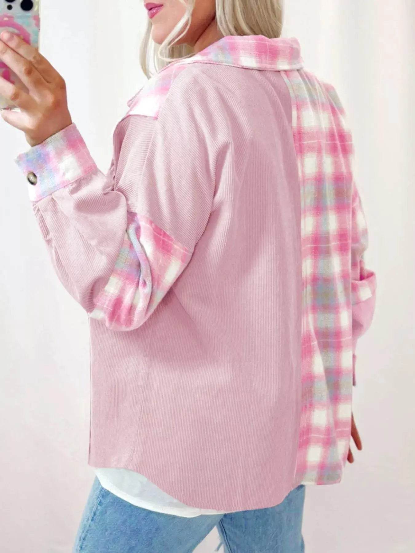 Pink corduroy shacket with plaid sleeves and back, worn by a person holding a phone.
