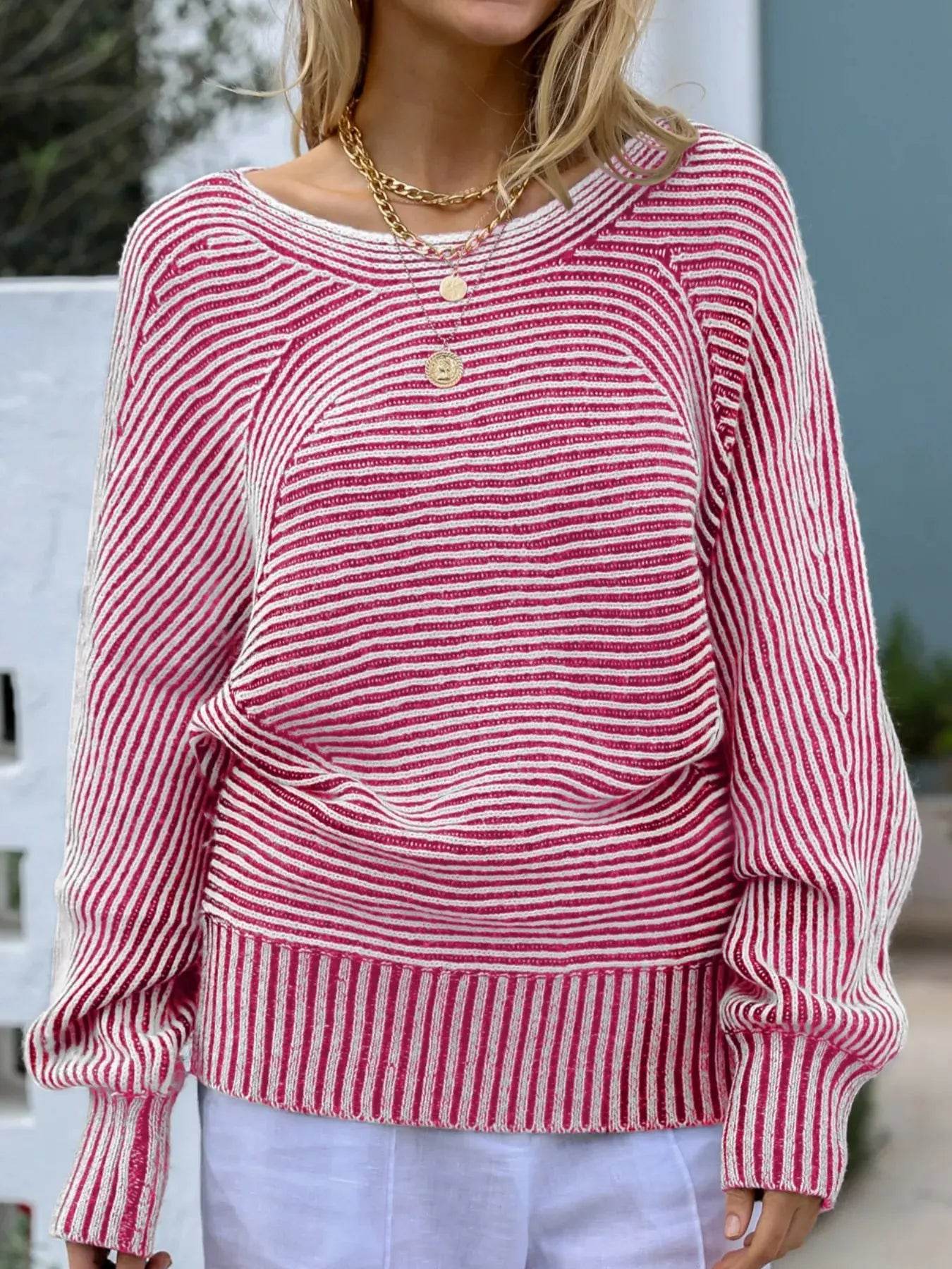Pink and white striped boat neck sweater with gold layered necklaces.