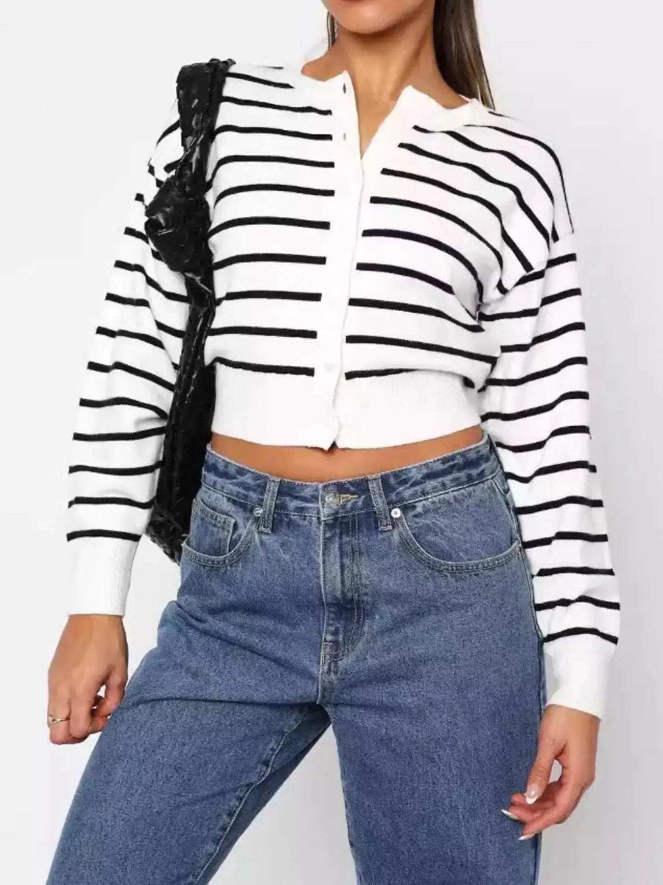 Women's striped button-up cardigan with blue jeans.