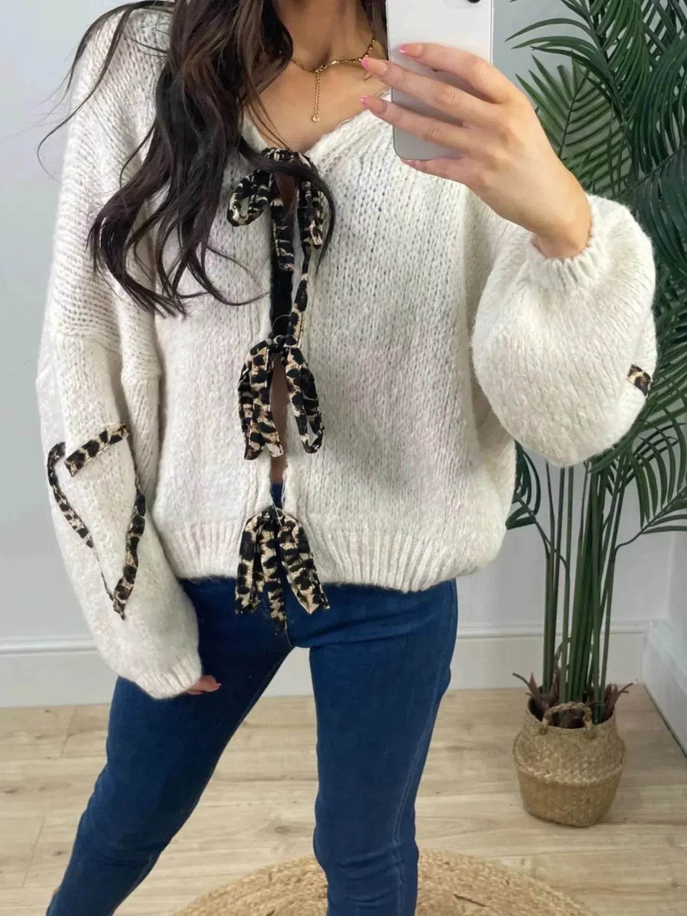 Women's knit top with a tie-front and long sleeves.