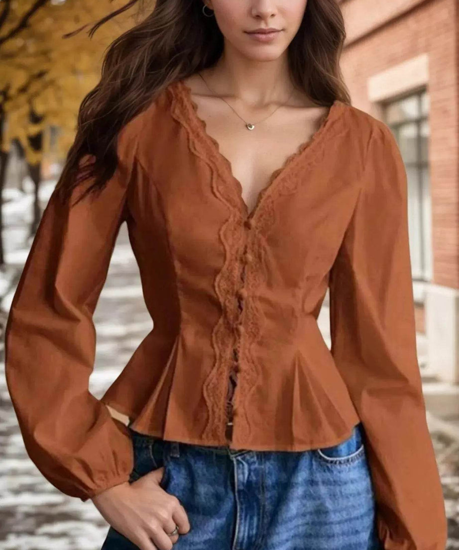 Lace detail balloon sleeve blouse in a rust color.