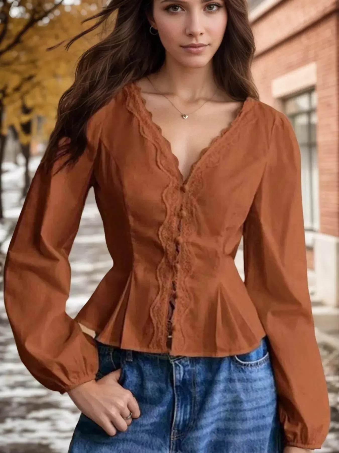 Lace detail balloon sleeve blouse in a rust color.