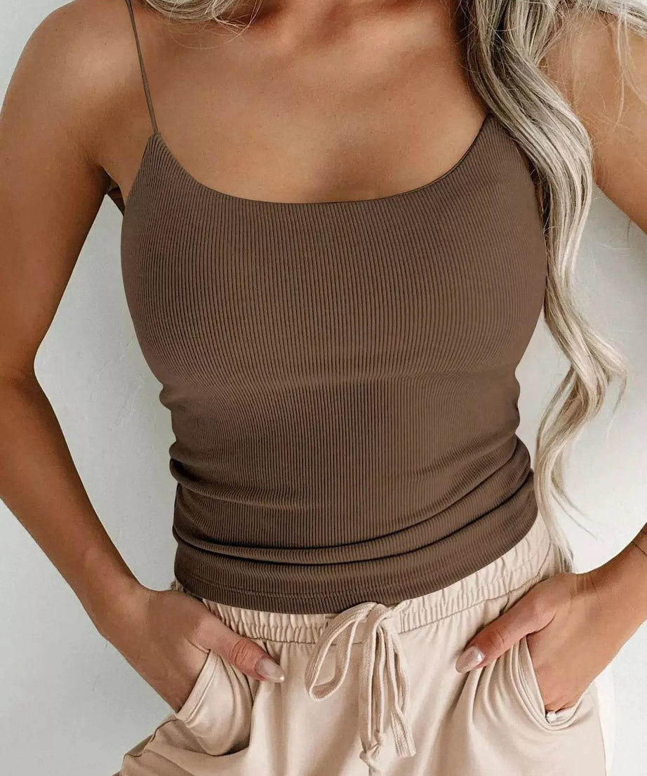 A woman models a brown ribbed rayon blend scoop neck cami and light-colored pants.