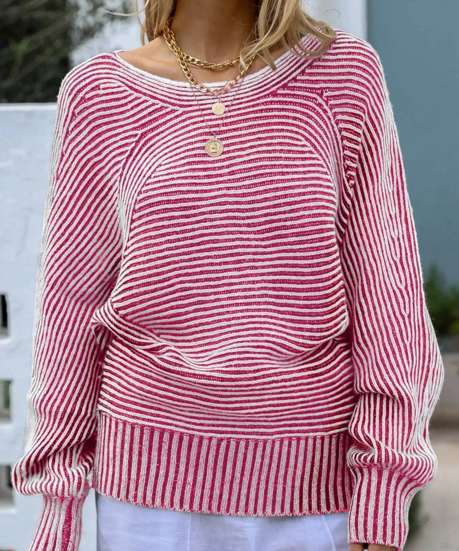 Pink and white striped boat neck sweater with gold layered necklaces.