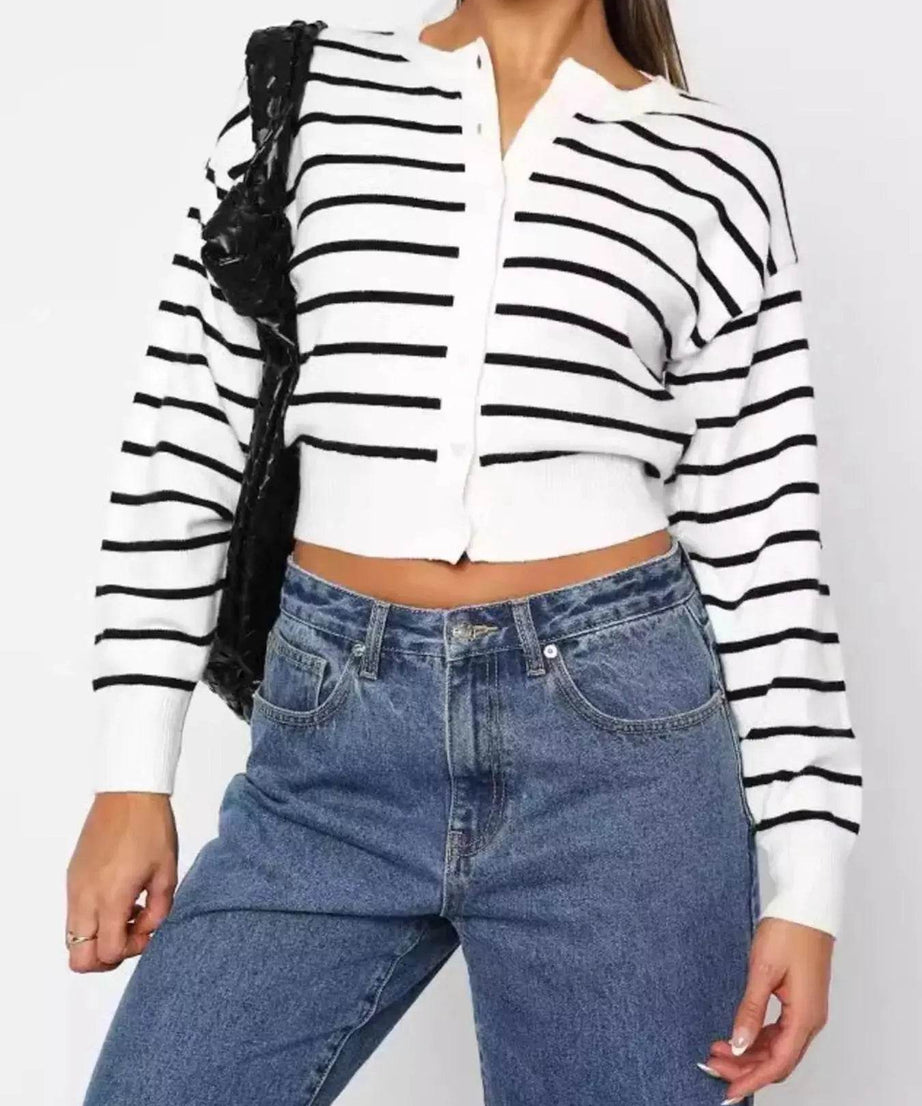Women's striped button-up cardigan with blue jeans.