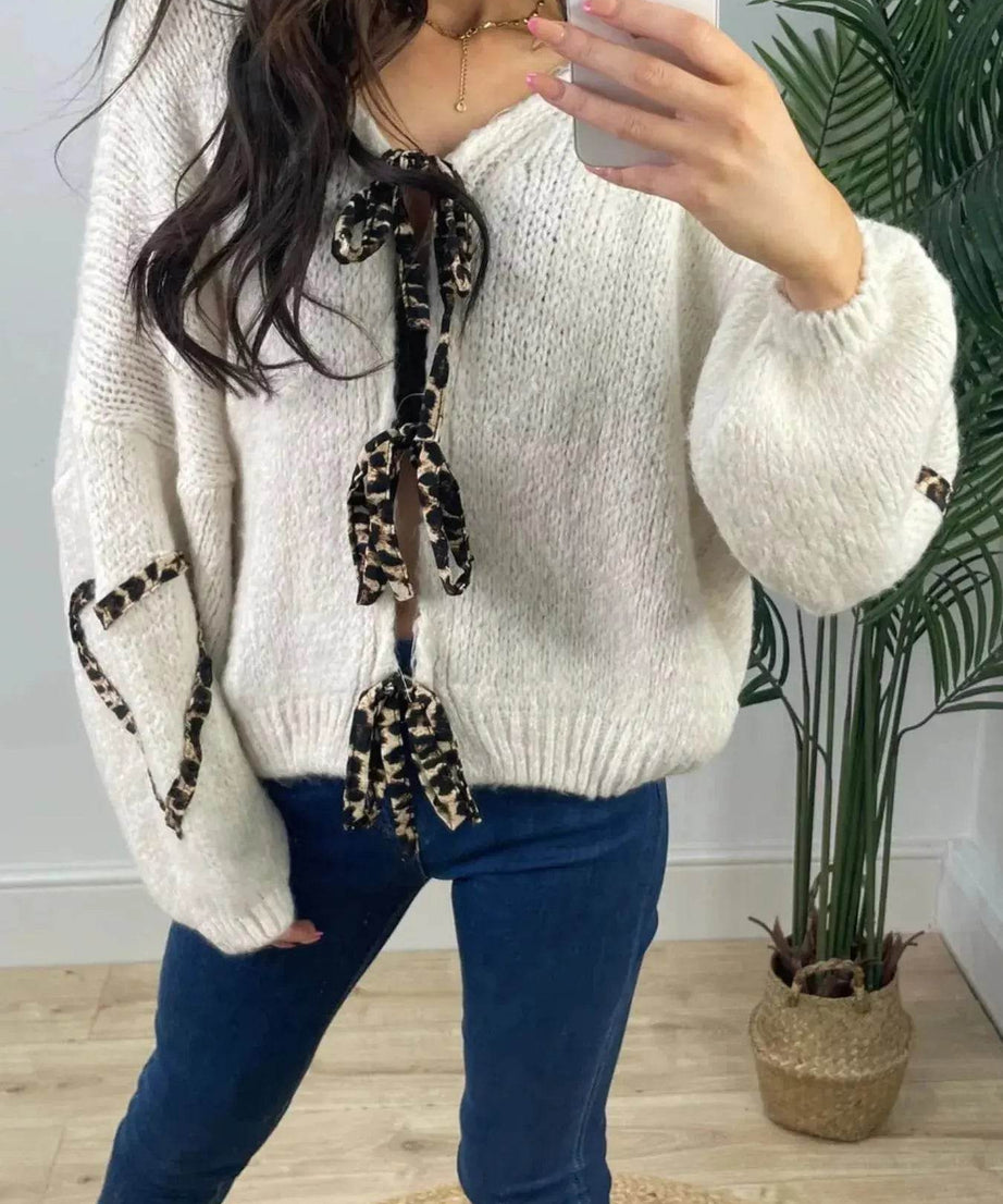 Women's knit top with a tie-front and long sleeves.